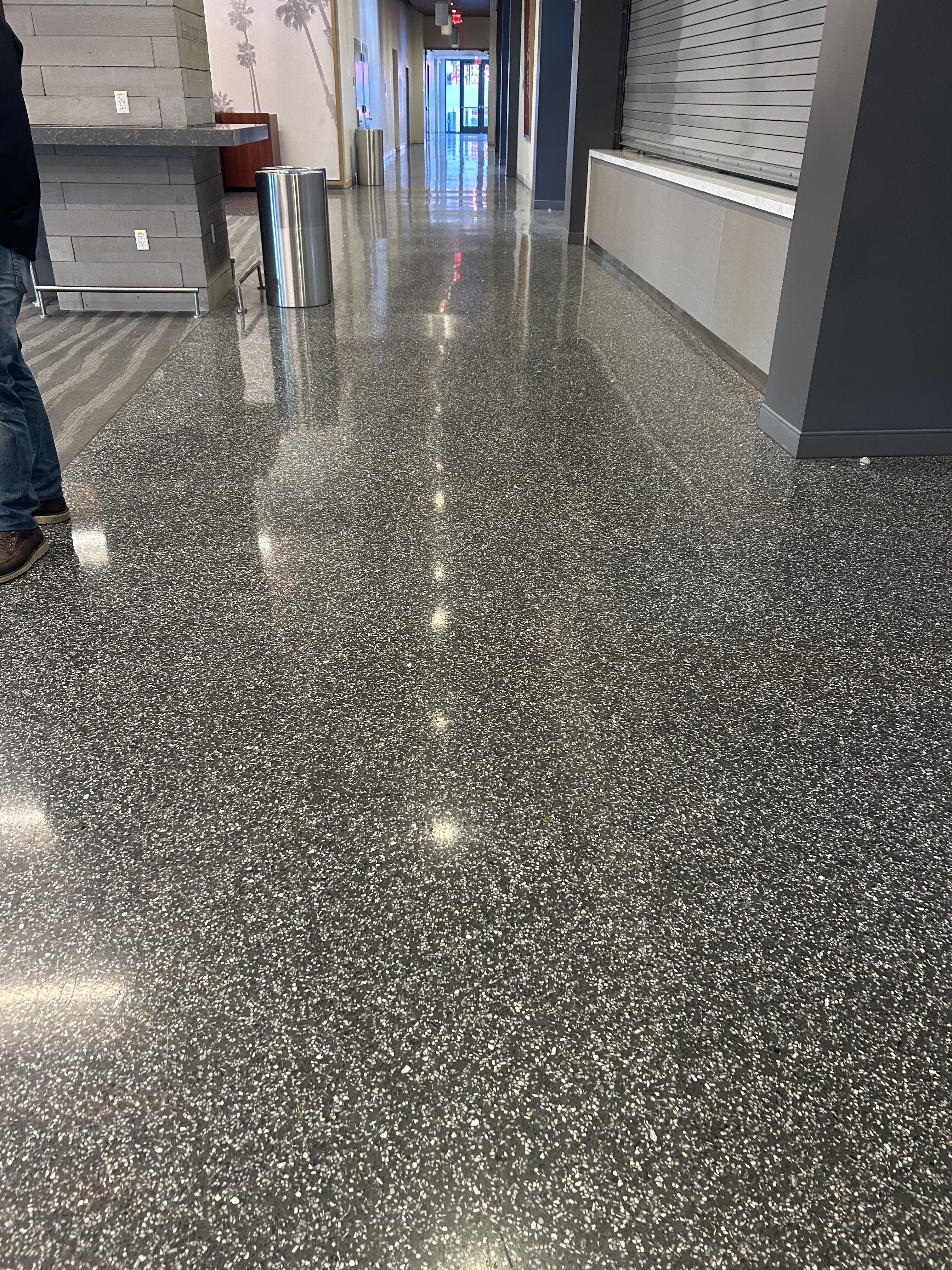 Restored speckled terrazzo floor with a reflective polish